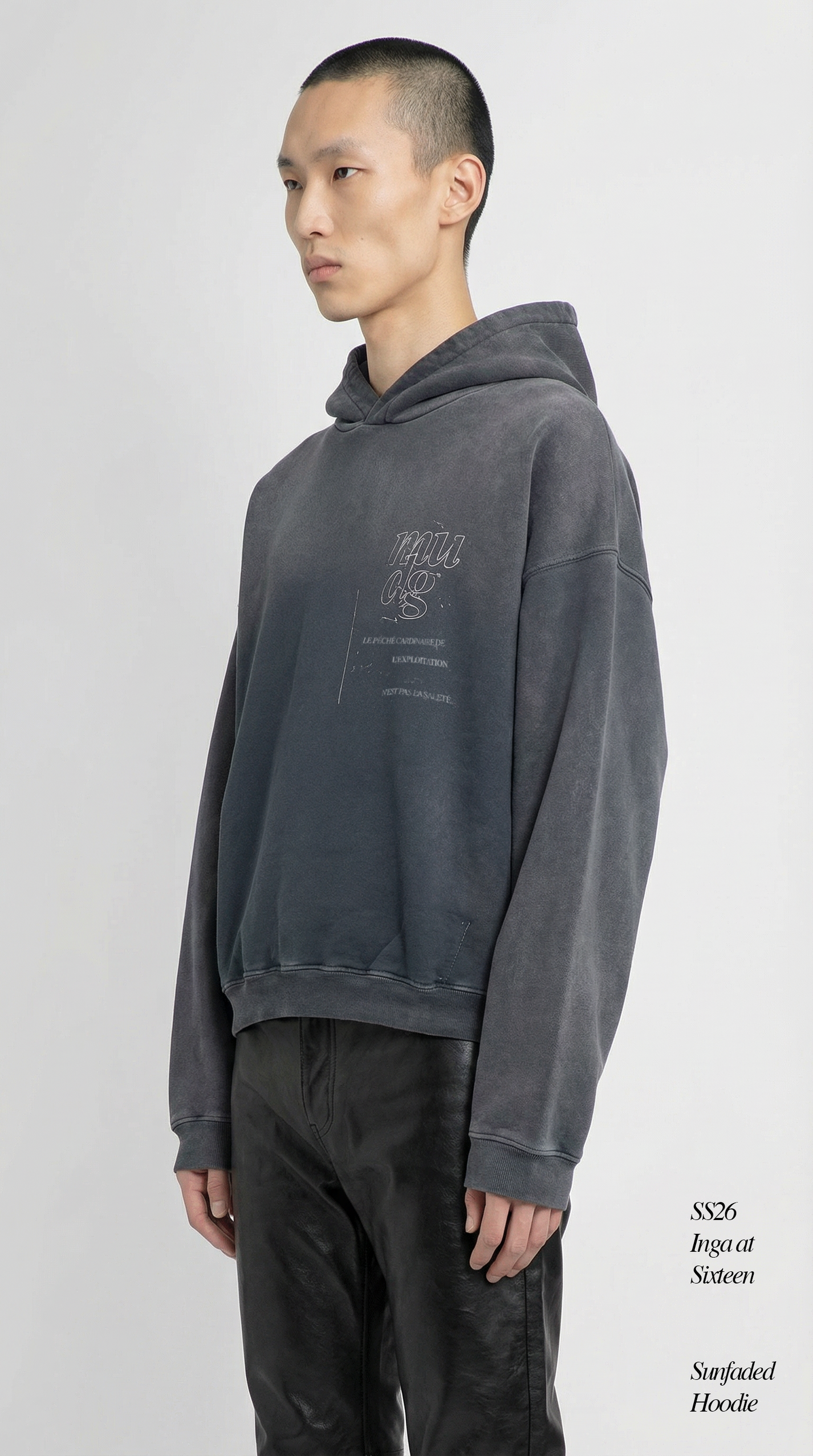 Person wearing a gray hoodie with text on a white background